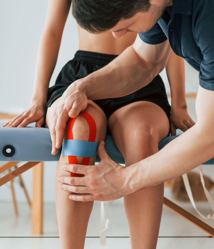 Physical Therapist applying kinesiology tape